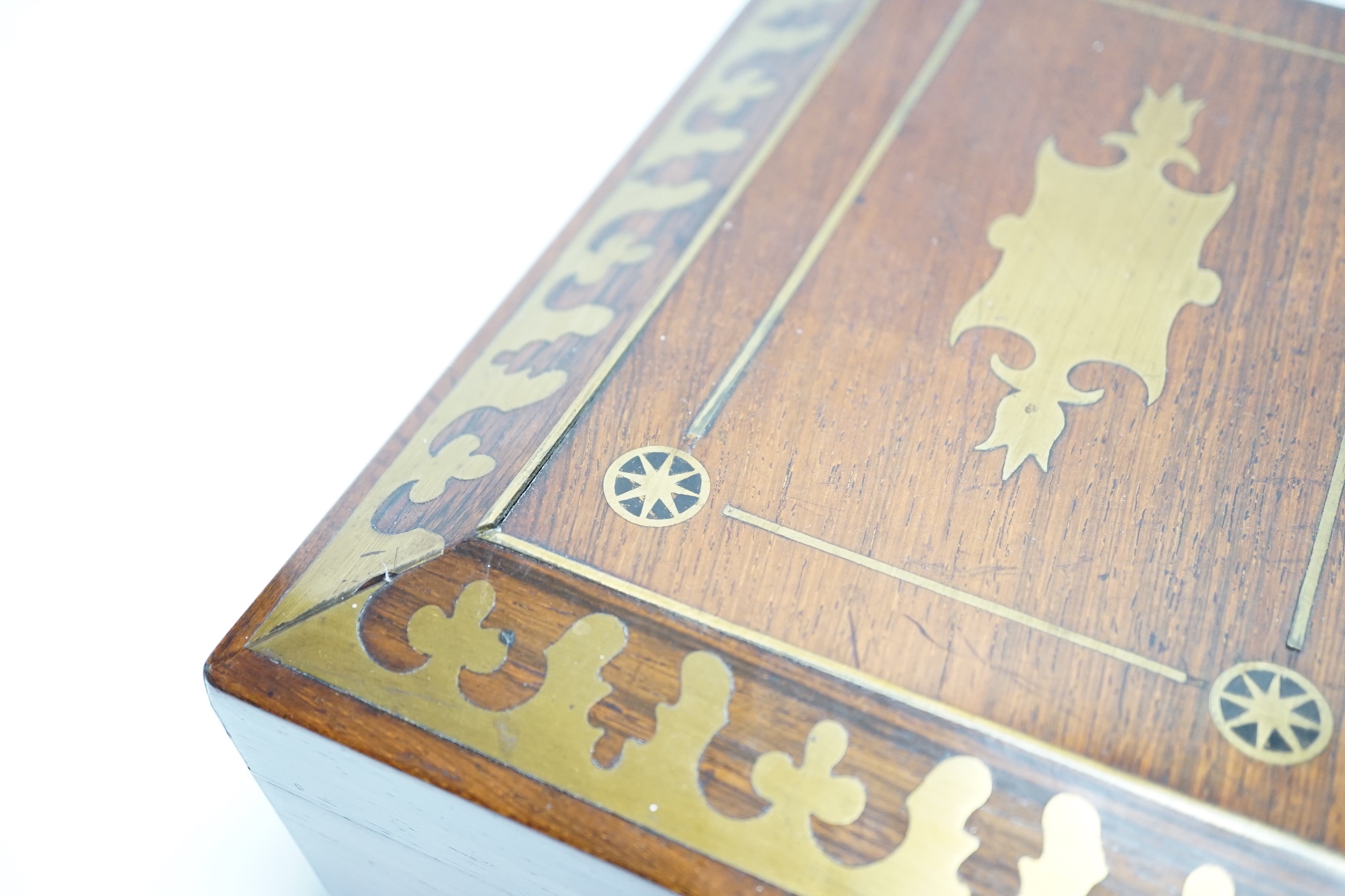 A George IV rosewood and cut brass sewing box with fitted interior, cotton reels, thread and sewing implements, 30cm wide